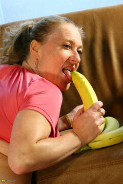 Naughty housewife playing with a banana