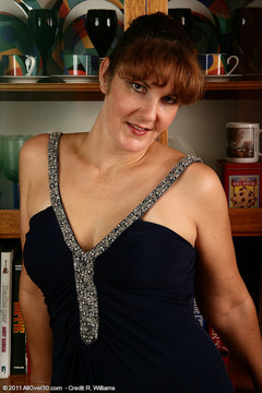 35 year old redheaded Julie slips out of her elegant dress and spreads